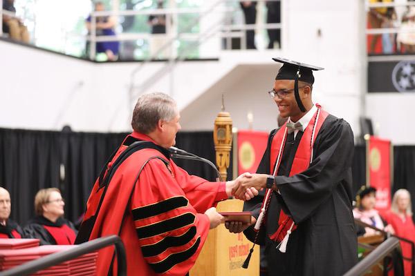 365bet President Mike Licari congratulates GYO grad Malachi Johnson.