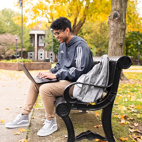 Student studies on browning lawn